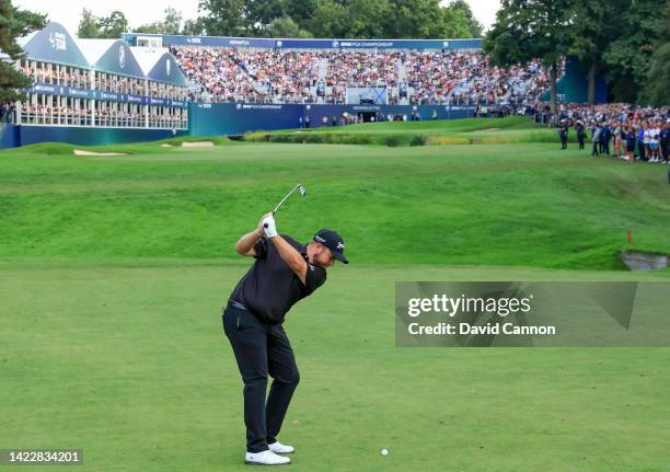 Shane Lowry of Ireland plays his second shot on the 18th hole after holing out for a winning birdie during the final round on day four of the BMW PGA...