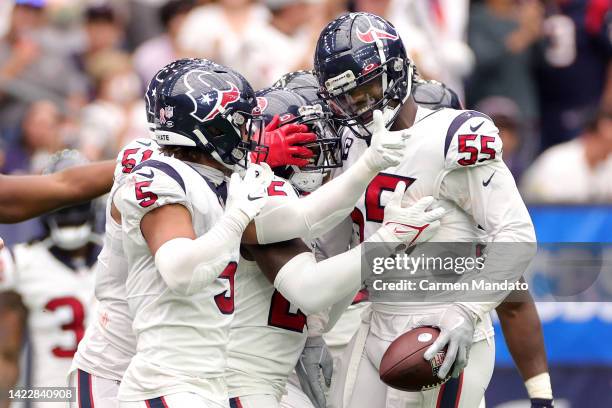 Jerry Hughes of the Houston Texans celebrates with teammates after intercepting a pass during the second quarter against the Indianapolis Colts at...