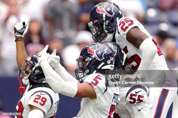 Jerry Hughes of the Houston Texans celebrates with teammates after intercepting a pass during the second quarter against the Indianapolis Colts at...