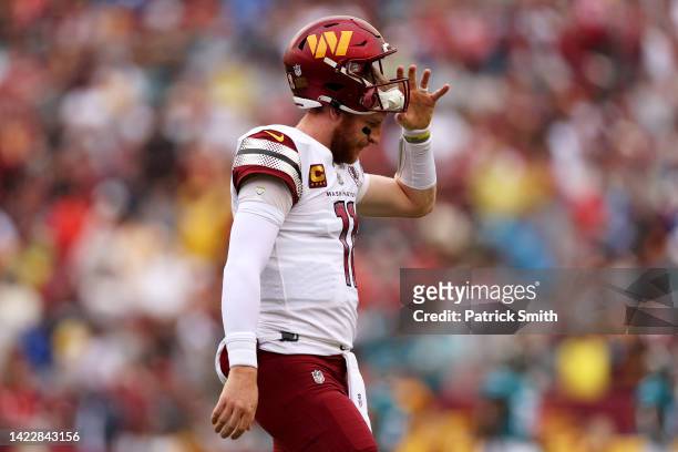 Carson Wentz of the Washington Commanders reacts during the first half against the Jacksonville Jaguars at FedExField on September 11, 2022 in...