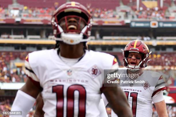 Curtis Samuel of the Washington Commanders and Carson Wentz celebrate after scoring a touchdown during the first quarter against the Jacksonville...