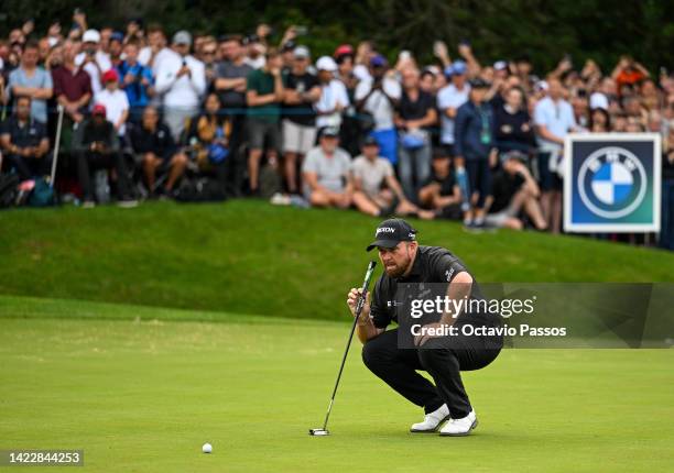 Shane Lowry of Ireland lines before plays his third shot on the 18th hole during Day Four of the BMW PGA Championship at Wentworth Golf Club on...