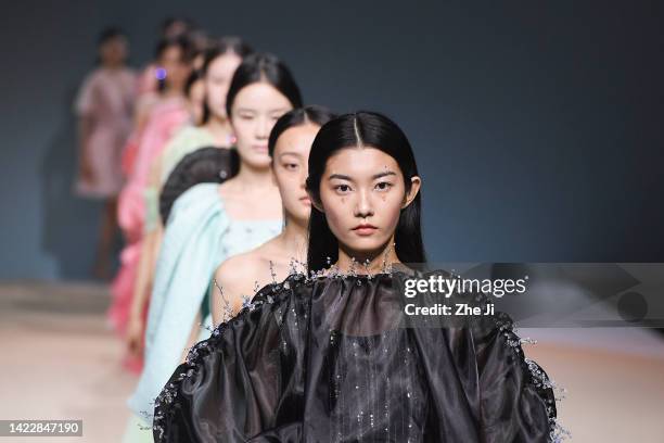 Models walk the runway during the JOOOYS show by designer Biao Cai on day 8 of China Fashion Week 2023 S/S at 751D.PARK on September 11, 2022 in...