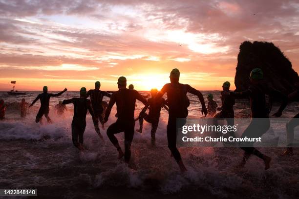 The professional men enter the water as they begin the race by starting with the swim leg during the IRONMAN Wales on September 11, 2022 in Tenby,...