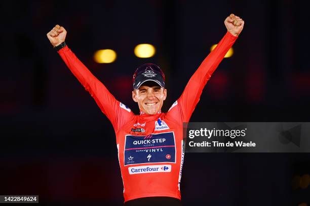 Remco Evenepoel of Belgium and Team Quick-Step - Alpha Vinyl celebrates winning the Red Leader Jersey on the podium ceremony after the 77th Tour of...