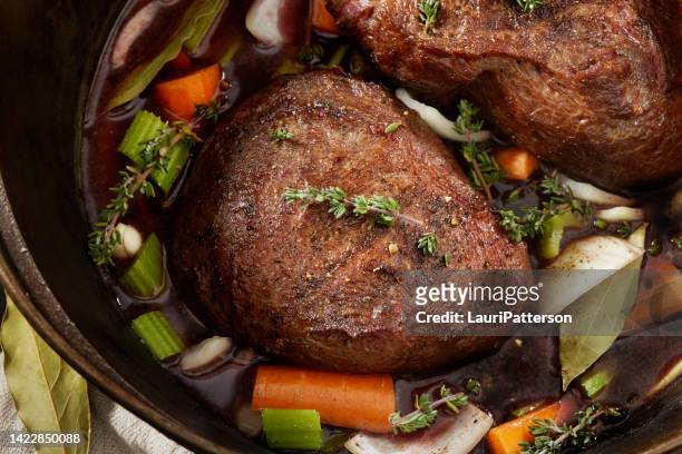 preparing red wine braised beef cheeks - iron wine stock pictures, royalty-free photos & images