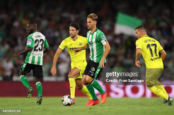 Sergio Canales of Real Betis runs with the ball while under pressure from Alfonso Pedraza of Villarreal CF during the LaLiga Santander match between...