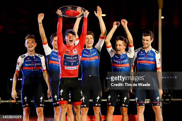 Remco Evenepoel of Belgium - Red Leader Jersey and Team Quick-Step - Alpha Vinyl celebrates winning with his teammates on the podium ceremony after...