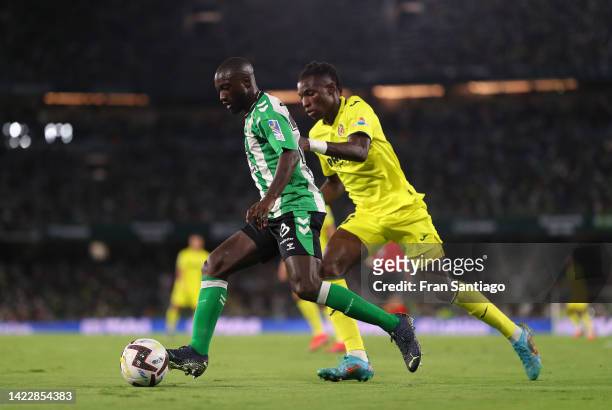 Youssouf Sabaly of Real Betis is put under pressure by Nicolas Jackson of Villarreal CF during the LaLiga Santander match between Real Betis and...