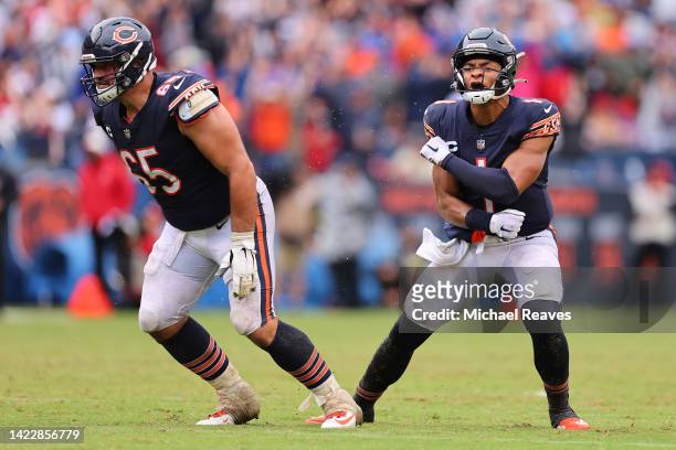Quarterback Justin Fields of the Chicago Bears celebrates with center Cody Whitehair of the Chicago Bears after throwing a touchdown pass during the...