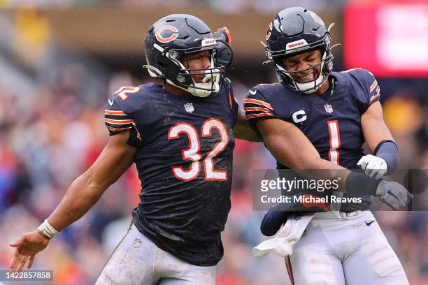 Running back David Montgomery of the Chicago Bears celebrates with quarterback Justin Fields of the Chicago Bears after Fields' touchdown pass during...