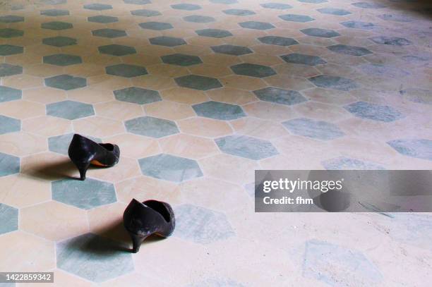 ghost shoes in an abandoned building - drab colored stock pictures, royalty-free photos & images