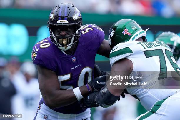 Justin Houston of the Baltimore Ravens rushes the passer against Laken Tomlinson of the New York Jets during the third quarter of the game at MetLife...