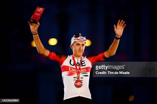 Marc Soler Gimenez of Spain and UAE Team Emirates celebrates winning the trophy for the most combative rider on the podium ceremony after the 77th...