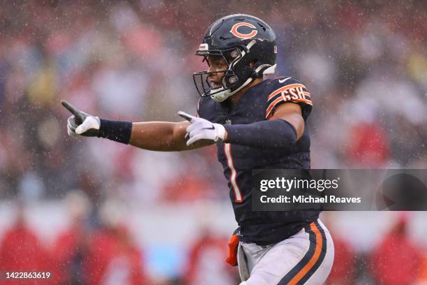 Quarterback Justin Fields of the Chicago Bears celebrates after a touchdown by running back Khalil Herbert of the Chicago Bearsduring the fourth...