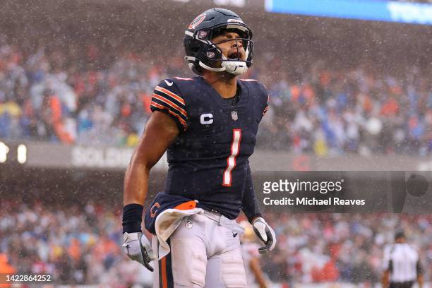 Quarterback Justin Fields of the Chicago Bears celebrates a rushing touchdown by running back Khalil Herbert of the Chicago Bears during the fourth...