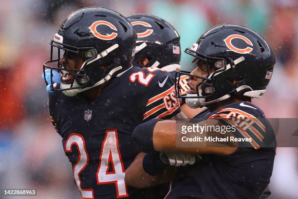 Running back Khalil Herbert of the Chicago Bears and quarterback Justin Fields of the Chicago Bears celebrate after Herberat Soldier Field on...
