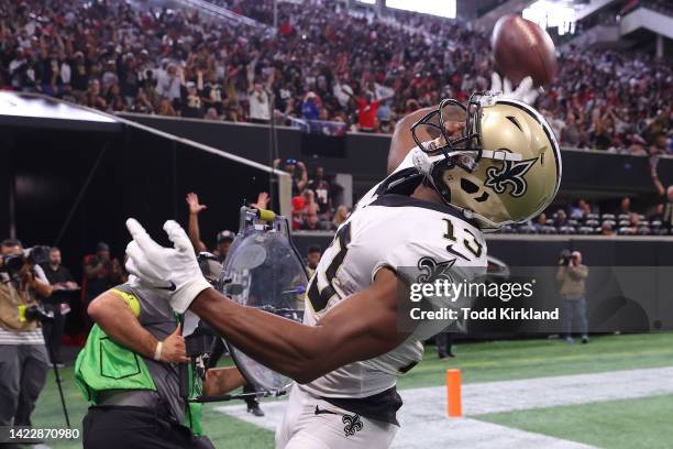 Wide receiver Michael Thomas of the New Orleans Saints throws the ball into the stands after a touchdown during the fourth quarter against the...