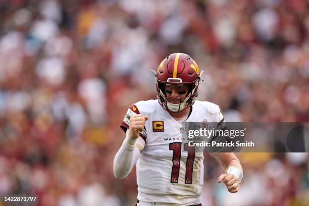 Carson Wentz of the Washington Commanders celebrates a two point conversion during the fourth quarter against the Jacksonville Jaguars at FedExField...
