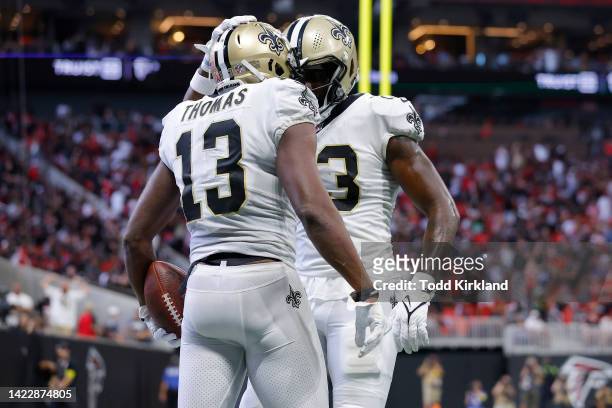Tight end Juwan Johnson of the New Orleans Saints celebrates with wide receiver Michael Thomas of the New Orleans Saints after Thomas' touchdown...