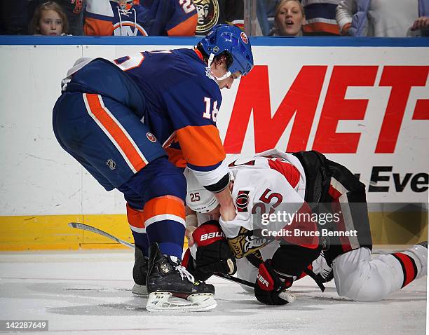 Micheal Haley of the New York Islanders takes a third period roughing penalty against Chris Neil of the Ottawa Senators at the Nassau Veterans...