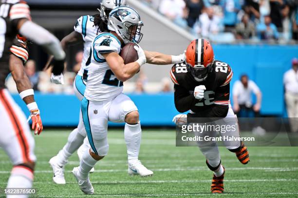 Christian McCaffrey of the Carolina Panthers stiff-arms Jeremiah Owusu-Koramoah of the Cleveland Browns during the first half of their game at Bank...