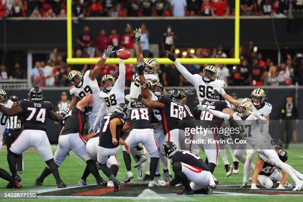 Defensive end Payton Turner of the New Orleans Saints blocks a game winning field goal attempt by place kicker Younghoe Koo of the Atlanta Falcons...