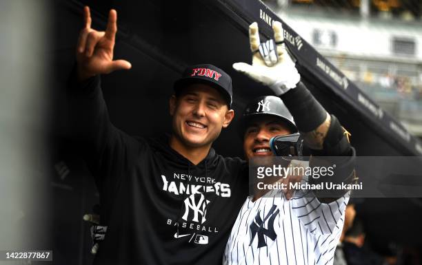 Gleyber Torres of the New York Yankees celebrates with teammate Anthony Rizzo after connecting for his second home run of the day during the bottom...