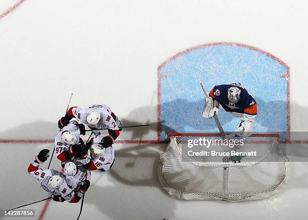 The Ottawa Senators celebrate a goal by Kyle Turris at 16:40 of the first period against Al Montoya of the New York Islanders at the Nassau Veterans...