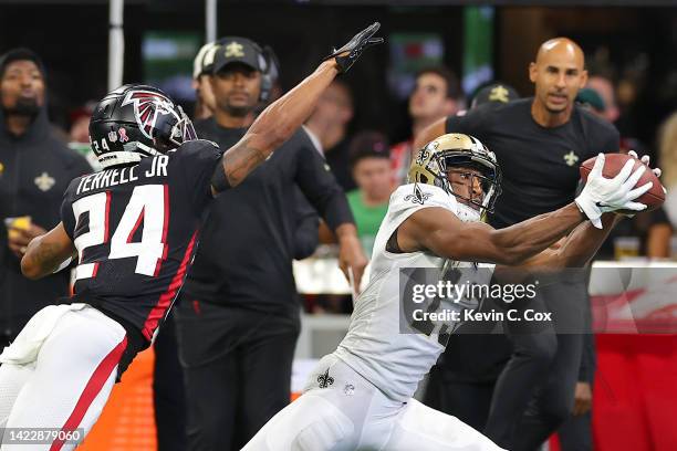 Wide receiver Michael Thomas of the New Orleans Saints catches a pass over cornerback A.J. Terrell of the Atlanta Falcons during the second half at...