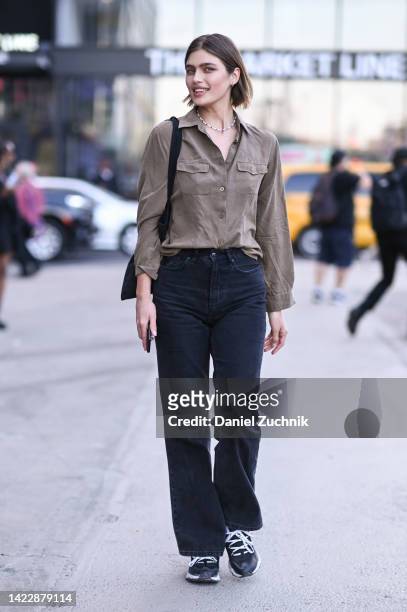 Model is seen wearing a brown shirt, black jeans and black bag outside the Tibi show during New York Fashion Week S/S 2023 on September 10, 2022 in...