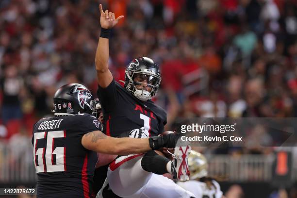 Guard Colby Gossett of the Atlanta Falcons celebrates with quarterback Marcus Mariota of the Atlanta Falcons after his rushing touchdown during the...