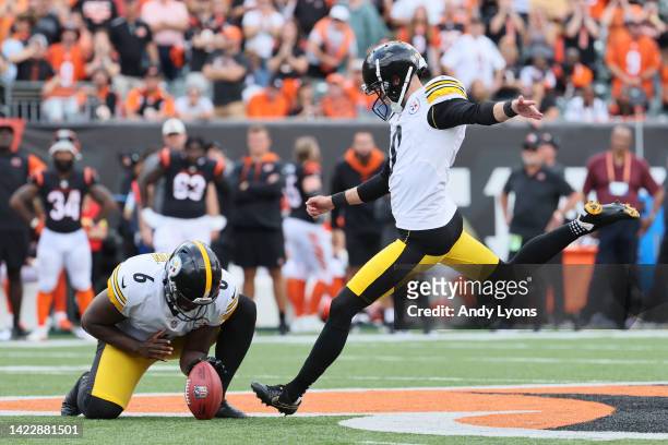 Punter Pressley Harvin III of the Pittsburgh Steelers holds the ball as place kicker Chris Boswell of the Pittsburgh Steelers kicks a game winning...