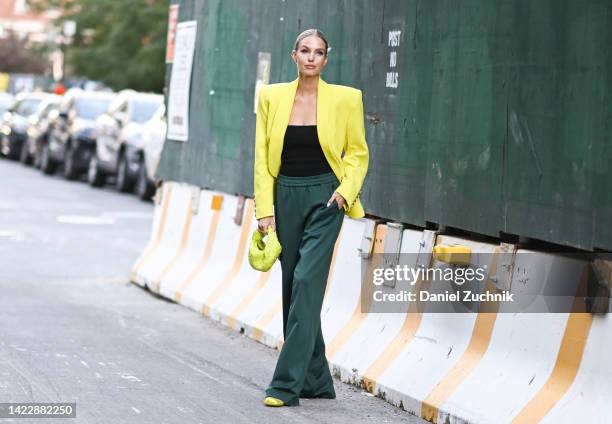 Leonie Hanne is seen wearing a lime green jacket, black top and green pants outside the Tibi show during New York Fashion Week S/S 2023 on September...