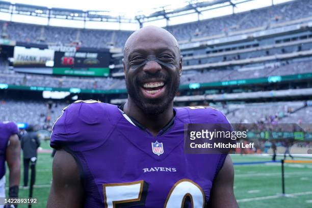 Outside Linebacker Justin Houston of the Baltimore Ravens celebrates on the field after defeating the New York Jets 24-9 at MetLife Stadium on...
