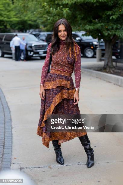 Katie Holmes wearing dress, black boots outside Ulla Johnson on September 11, 2022 in New York City.
