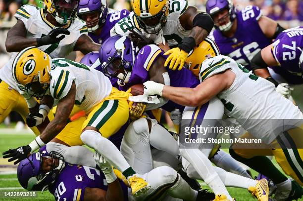 Dalvin Cook of the Minnesota Vikings runs with the ball during the second quarter in the game against the Green Bay Packers at U.S. Bank Stadium on...
