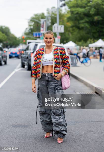 Janka Polliani wearing cropped top, denim jeans, colorful jacket, pink Chanel bag outside Ulla Johnson on September 11, 2022 in New York City.