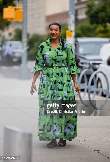 Guest wearing green belted dress outside Ulla Johnson on September 11, 2022 in New York City.