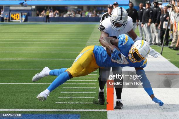 Tight end Gerald Everett of the Los Angeles Chargers dives into the end zone in front of safety Roderic Teamer of the Las Vegas Raiders during the...