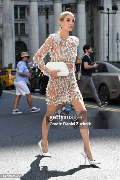 Leonie Hanne is seen wearing a white beaded Patbo dress and white bag outside the Patbo show during New York Fashion Week S/S 2023 on September 10,...