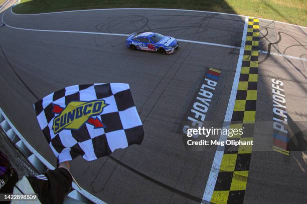 Bubba Wallace, driver of the ROOT Insurance Toyota, takes the checkered flag to win the NASCAR Cup Series Hollywood Casino 400 at Kansas Speedway on...