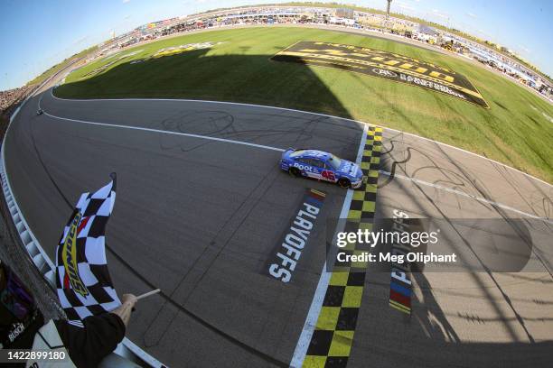 Bubba Wallace, driver of the ROOT Insurance Toyota, takes the checkered flag to win the NASCAR Cup Series Hollywood Casino 400 at Kansas Speedway on...