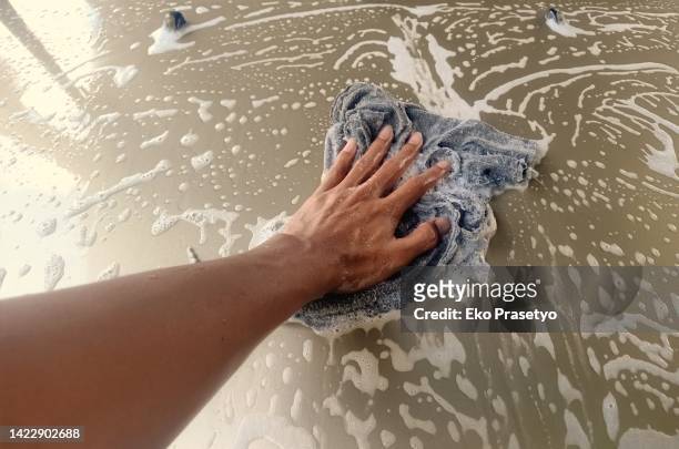 clean the stains on the car body with a micro fiber cloth - microfiber towel stock pictures, royalty-free photos & images