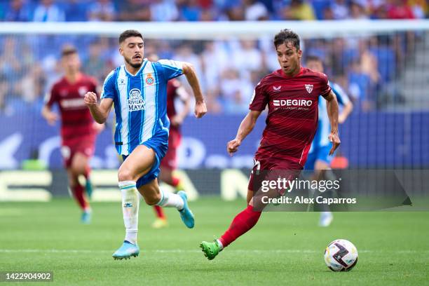 Oliver Torres of Sevilla FC runs with the ball whilst under pressure from Oscar Gil of RCD Espanyol during the LaLiga Santander match between RCD...