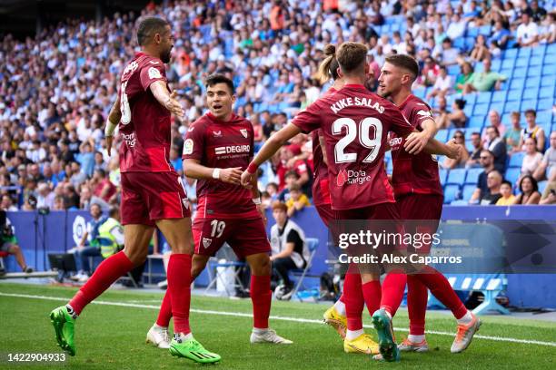 Jose Angel Carmona of Sevilla FC celebrates with teammates after scoring his team's second goal during the LaLiga Santander match between RCD...
