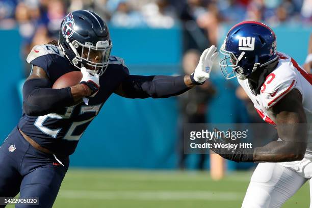 Running back Derrick Henry of the Tennessee Titans stiff arms linebacker Jihad Ward of the New York Giants during the first half at Nissan Stadium on...