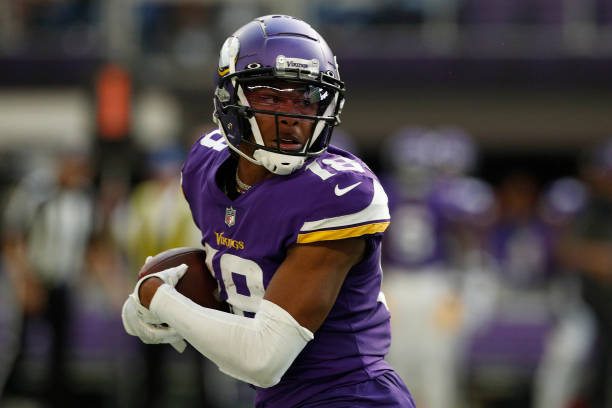 Wide Receiver Justin Jefferson of the Minnesota Vikings catches a pass to score against the Green Bay Packers during the second quarter of the game...