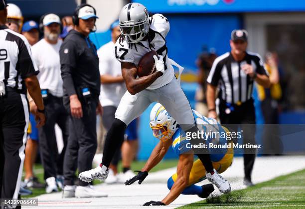 Wide receiver Davante Adams of the Las Vegas Raiders is knocked out of bounds by safety Duron Harmon of the Las Vegas Raiders during the first half...