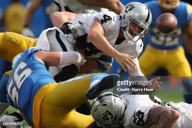 Quarterback Derek Carr of the Las Vegas Raiders fumbles the ball during the fourth quarter against the Los Angeles Chargers at SoFi Stadium on...